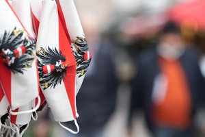 Protective masks with the motif of the Austrian flag hang on a sales stand on Naschmarkt in Vienna during the coronavirus pandemic on November 17, 2020, Austria