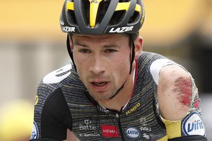 FILE- In this Monday, June 28, 2021, file photo Slovenia's Primoz Roglic crosses the finish line after crashing during the third stage of the Tour de France cycling race over 182.9 kilometers (113.65 miles) with start in Lorient and finish in Pontivy, France