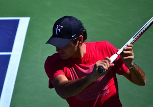 Roger Federer makes a backhand return at the tennis tournament