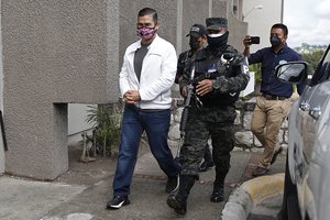 Roberto David Castillo is escorted by penitentiary police to hear the verdict by the Supreme Court in his trial connected to accusations that he is one of the intellectual authors responsible for the murder of environmentalist and Indigenous rights activist Berta Caceres, in Tegucigalpa, Honduras, Monday, July 5, 2021