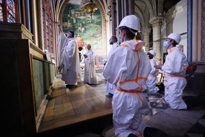 Paris archbishop Michel Aupetit, left, celebrates a mass next to Patrick Chauvet , center, Notre-Dame de Paris' rector, during a mass to call for more donations by faithfuls for the renovation of the monument ravaged two years ago by a fire at Notre Dame Cathedral Wednesday June 16 2021 in Paris.