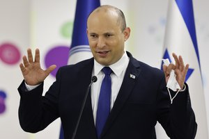 Israeli Prime Minister Naftali Bennett gestures as he delivers a statement during his visit to a Maccabi healthcare maintenance organisation (HMO) outlet which offers vaccinations against the coronavirus disease (COVID-19) in Holon, near Tel Aviv, Israel Tuesday, June 29, 2021