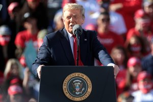 Donald Trump speaking with supporters at a "Make America Great Again" campaign rally at Phoenix Goodyear Airport in Goodyear, Arizona