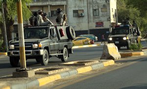 In this May 26, 2021 file photo, Popular Mobilization Forces, PMF, patrol outside the heavily fortified Green Zone, where the Prime Minister's headquarters is in Baghdad, Iraq