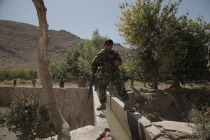 Executive Officer from Afghan National Army 2nd Candac 205th Corp performs a site survey to find the best area for checkpoint four during Operation Fairbanks in Qalat, Zabul Province, Afghanistan, Sept. 20, 2011