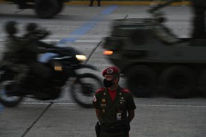 A soldier stands guard during a military parade marking Independence Day in Caracas, Venezuela, Monday July 5, 2021. Venezuela is marking 210 years of their declaration of independence from Spain