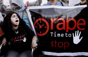 FILE - In this June 14, 2014 file photo, Egyptian women shout slogans and hold banners during a protest against sexual assaults, in Cairo, Egypt