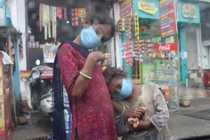 Hungry homeless beggar on the street begging for money wearing mask to protect from coronavirus during the pandemic, Jammu, India, 04 May 2021.