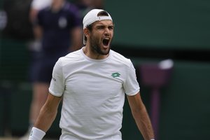 Italy's Matteo Berrettini celebrates after defeating Poland's Hubert Hurkacz during the men's singles semifinals match on day eleven of the Wimbledon Tennis Championships in London, Friday, July 9, 2021