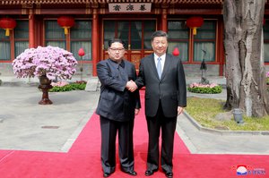 File - In this March 27, 2018, photo, North Korean leader Kim Jong Un, left, shakes hands with Chinese counterpart Xi Jinping at Diaoyutai State Guesthouse in Beijing, China.