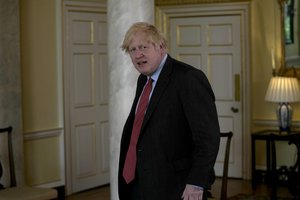 British Prime Minister Boris Johnson walks in for his meeting with Libyan interim Prime Minister Abdulhamid Dabaiba, inside 10 Downing Street in London, Thursday, June 24, 2021