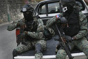 Soldiers stand guard near of Interim President Claude Joseph residence in Port-au-Prince, Haiti, Sunday, July 11, 2021, four days after the assassination of Haitian President Jovenel Moise.