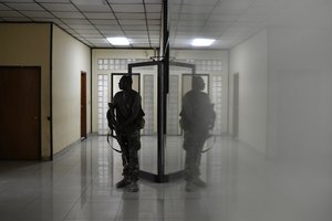 A bodyguard stands outside the prosecutors office that is investigating the assassination of President Jovenel Moise inside the courthouse in Port-au-Prince, Haiti, Wednesday, July 14, 2021.