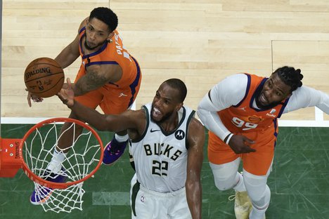 Phoenix Suns guard Cameron Payne, left, and Jae Crowder, right, during Game 4 of basketball's NBA Finals in Milwaukee, Wednesday, July 14, 2021