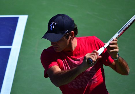 Roger Federer makes a backhand return at the tennis tournament