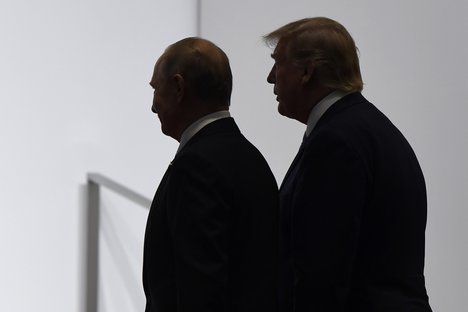 FILE - In this June 28, 2019, file photo, President Donald Trump and Russian President Vladimir Putin walk to participate in a group photo at the G20 summit in Osaka, Japan.