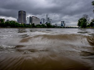 Water flows on the river Main in Frankfurt, Germany, Wednesday July 14, 2021. Strong rain falls have caused flooding and rising river levels in some parts of Germany.