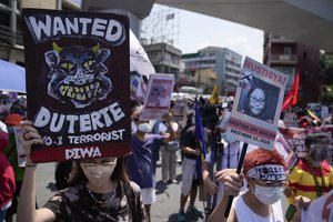 Protesters hold slogans during a rally outside the Malacanang palace in Manila, Philippines on Wednesday, June 30, 2021. The group has called for justice and accountability for the thousands who have died due to the government's anti-drug crackdown under the Duterte administration.