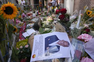 HIs picture and flowers mark the spot where journalist Peter R. de Vries was shot in Amsterdam, Netherlands, Thursday, July 8, 2021.