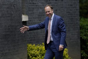 Britain's Health Secretary Matt Hancock waves at members of the media as he walks to go into 10 Downing Street, in London, Monday, June 7, 2021