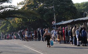 Shoppers queue to buy essentials at a mall in Durban, South Africa, Saturday, July 17, 2021, after a weeklong of unrest.