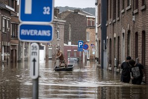 A man rows a boat down a residential street after flooding in Angleur, Province of Liege, Belgium, Friday July 16, 2021. Severe flooding in Germany and Belgium has turned streams and streets into raging torrents that have swept away cars and caused houses to collapse.