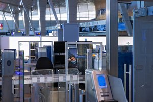 A transportation security administration agent sits at a checkpoint at Ben Gurion Airport, Israel's main international hub