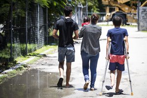 In this Sept. 4, 2018, photo, from left, Mohammad, 17, Aryana, 2 1/2 months old, his mother and little brother Amirparsa, 11, are pictured on Nauru. "We were innocent," says Mohammad about himself and other children. "It was not our fault to come out of our countries. It was not our fault to be in Nauru. We need future. We need education. We need to be in a normal place."