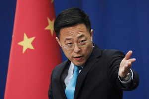 Chinese Foreign Ministry spokesperson Zhao Lijian gestures as he speaks during a daily briefing at the Ministry of Foreign Affairs office in Beijin