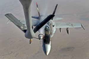 A U.S. Navy F-18E Super Hornet supporting operations against ISIL, receives fuel from a KC-135 Stratotanker over Iraq after conducting an airstrike, Oct. 4, 2014l)