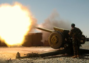 An artilleryman from the Afghan National Army's 205th Corps fires a round from a D-30 artillery piece during an indirect fire support mission, Sept. 9, 2007.