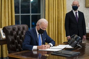 FILE - In this Tuesday, Feb. 2, 2021, file photo, Secretary of Homeland Security Alejandro Mayorkas looks on as President Joe Biden signs an executive order on immigration, in the Oval Office of the White House in Washington.