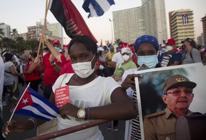 People attend a cultural-political event on the seaside Malecon Avenue with thousands of people in a show of support for the Cuban revolution six days after the uprising of anti-government protesters across the island, in Havana, Cuba, Saturday, July 17, 2021