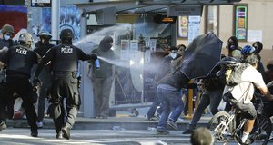 In this July 25, 2020, file photo, police pepper spray protesters, near Seattle Central College in Seattle, during a march and protest in support of Black Lives Matter.