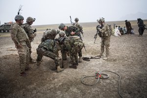 Afghan National Army soldiers with the 3rd Company, 6th Battalion and U.S. Soldiers with the 1st Battalion, 36th Infantry Regiment, help rescue a 3-year-old boy who had fallen into a well in Maiwand district, Kandahar province, Afghanistan, April 7, 2013