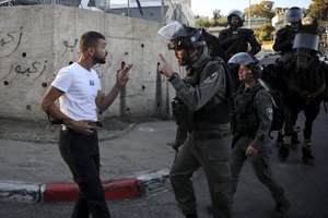 File - An Israeli Arab man argues with Israeli border police officer during a protest in the Sheikh Jarrah neighborhood of east Jerusalem, where several Palestinian families are under imminent threat of forcible eviction from their homes, Saturday, May 15, 2021.