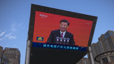 Chinese President Xi Jinping is seen on a big screen showing the Chinese state television CCTV news on Wednesday.