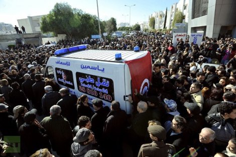 Ambulance carrying Chokri Belaid surrounded by protesters