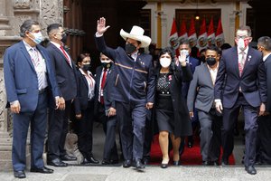 Peru's President-elect Pedro Castillo and his wife Lilia Paredes, wave as they leave the Foreign Ministry to go to Congress for his swearing-in ceremony on his Inauguration Day in Lima, Peru, Wednesday, July 28, 2021.