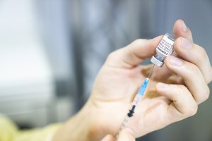 Coronavirus - Vaccination, Luxembourg: A nurse filling a syringe with a dose of the COVID-19 vaccine