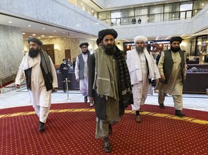 File - Taliban co-founder Mullah Abdul Ghani Baradar, center, arrives with other members of the Taliban delegation for attending an international peace conference in Moscow, Russia, Thursday, March 18, 2021.