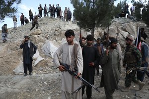 File - Afghan militiamen join Afghan defense and security forces during a gathering in Kabul, Afghanistan, Wednesday, June 23, 2021. Taliban gains in north Afghanistan, the traditional stronghold of the country's minority ethnic groups who drove the insurgent force from power nearly 20  years ago, has driven a worried government to resurrect militias whose histories have been characterized by chaos and widespread killing.