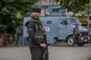 File - An Indian paramilitary soldier stands guard on a road leading towards the site of a gunfight in Pulwama, south of Srinagar, Indian controlled Kashmir, Wednesday, July 14, 2021.