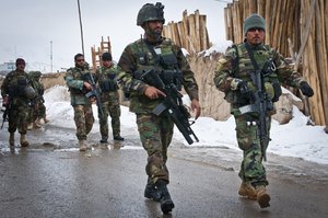 Afghan National Army soldiers who are part of an explosive ordinance disposal unit arrive on the scene where an improvised explosive device was found near the wood market in the city of Gardez, Dec. 2, 2011