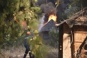 Firefighters operate during a wildfire near Lampiri village, west of Patras, Greece, Saturday, Jul. 31, 2021