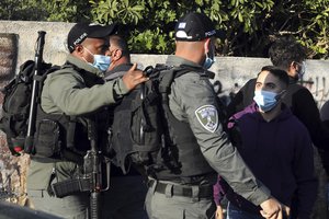 File - Israeli border police face off with a Palestinian during a protest against Israeli demolition of Palestinian homes in the Sheikh Jarrah district of Jerusalem, Friday, March 19, 2021.