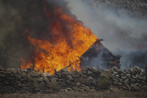 A fire engulfs a house in Cokertme village, near Bodrum, Mugla, Turkey, Tuesday, Aug. 3, 2021