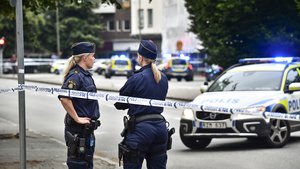 Police stand next to a cordon after four people were shot and injured on an open street in central Malmo, southern Sweden, on June 18, 2018. Police have no information on suspects so far.