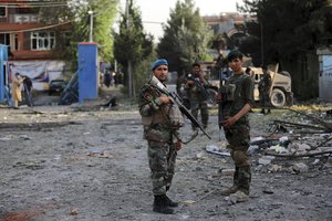 Afghan national army stand guard outside the house of acting defense minister, following an attack in Kabul, Afghanistan, Wednesday, Aug. 4, 2021