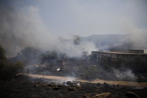 Fields burn following a hit by a rocket fired from Lebanon into Israeli territory, near the northern Israeli town of Kiryat Shmona, Wednesday, Aug. 4, 2021